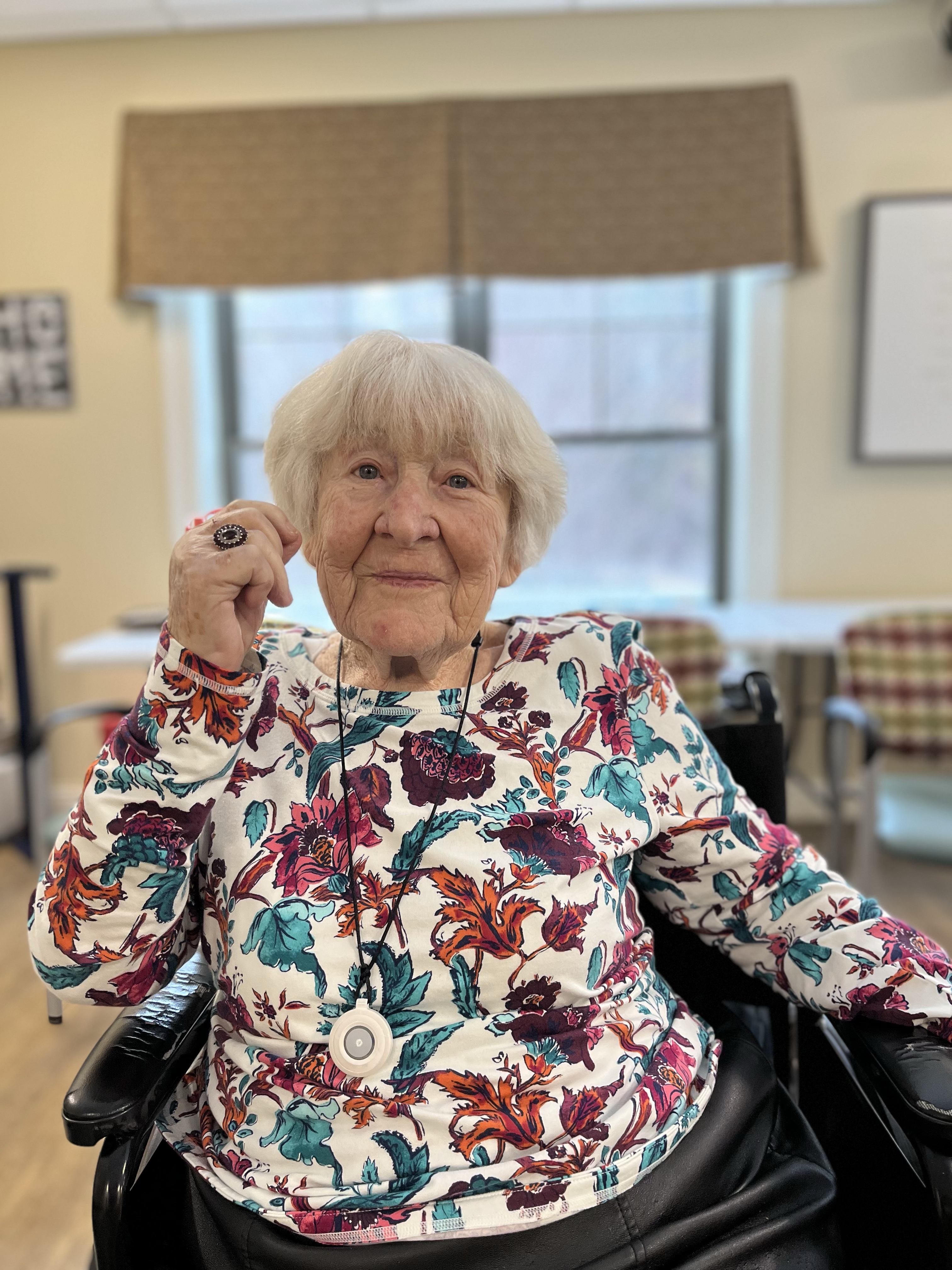 woman with floral shirt on smiling