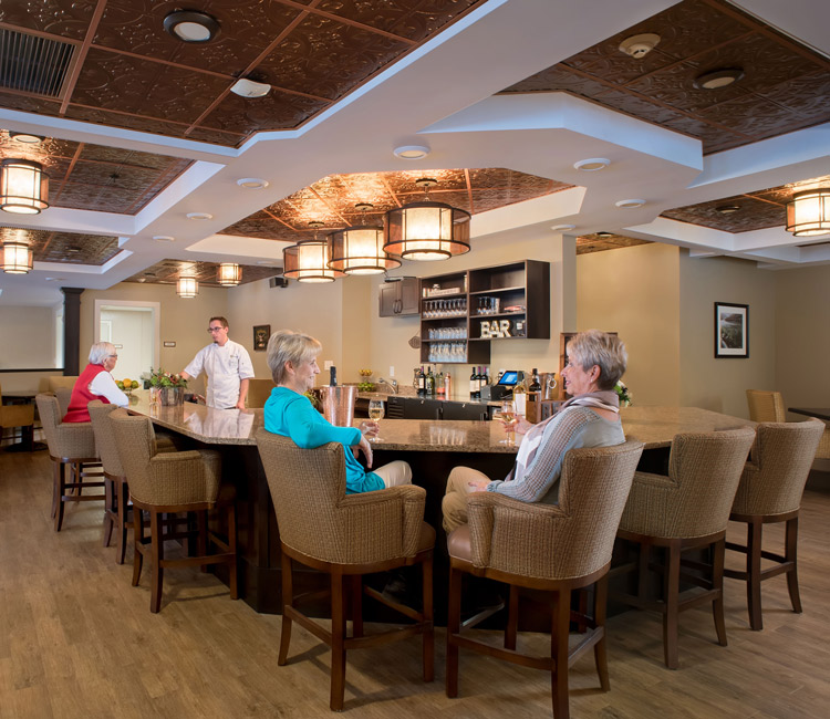 residents at stroudwater lodge sitting at cafe table and talking