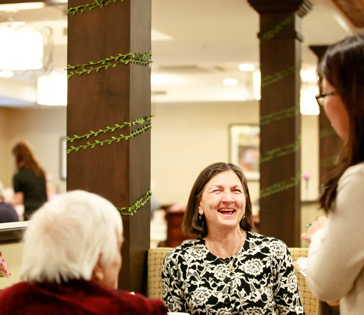 residents and staff smiling and talking