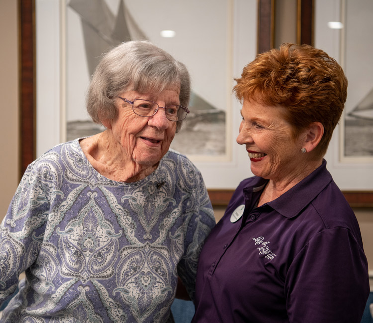 CNA assisting older woman resident