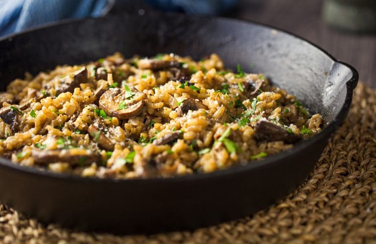 Home made vegan mushroom risotto,mixing the porcini mushroom and chestnut mushroom with coconut cream and fine chopped parsley