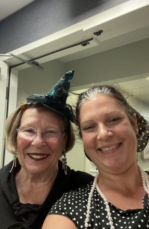 Staff member, Melissa, with a resident wearing a witches hat