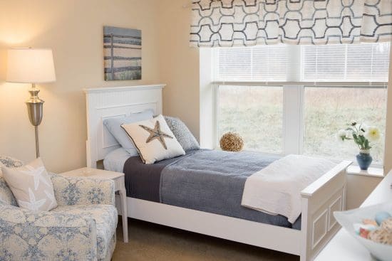 closeup of twin bed by window in bedroom