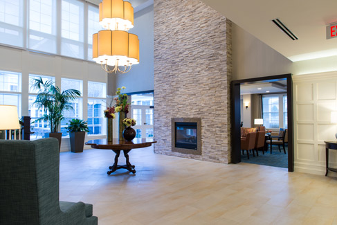 lobby area with tall fireplace at Stonebridge in Burlington, MA