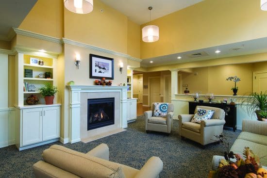 seating area with plush chairs facing a fireplace